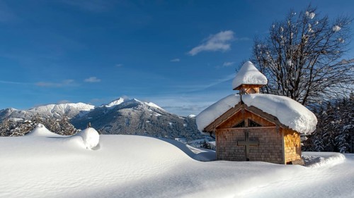 Wooden chapel with snow on Vomperberg