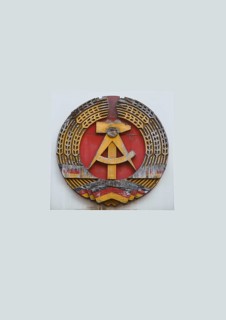 Coat of arms of the former GDR on the wall