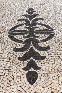 Black and white ornamental floor mosaic of paving stones