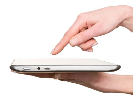 Finger pointing at a tablet computer screen