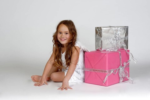 Girl as Christmas angel with presents
