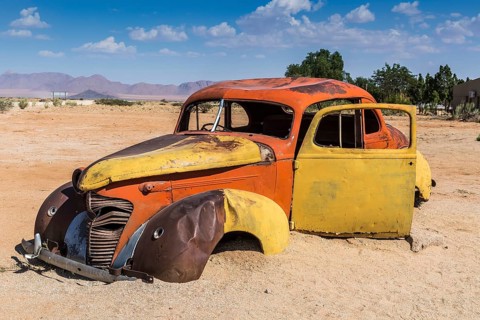 Old car wreck in sand
