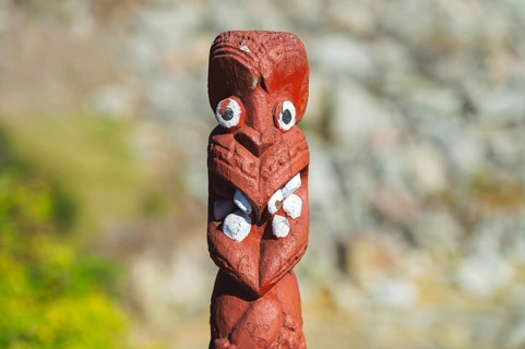 Artfully carved traditional statue of Maori made of wood