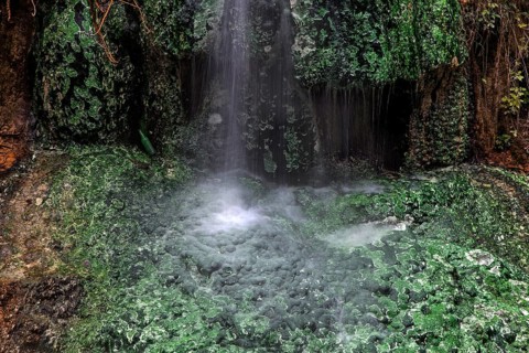 Small waterfall with green mineral deposits
