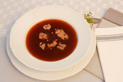 Oxtail soup with red pepper in soup plate