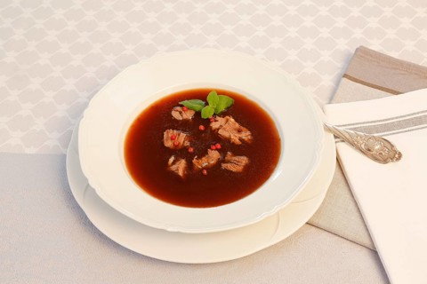 Oxtail soup with red pepper in soup plate