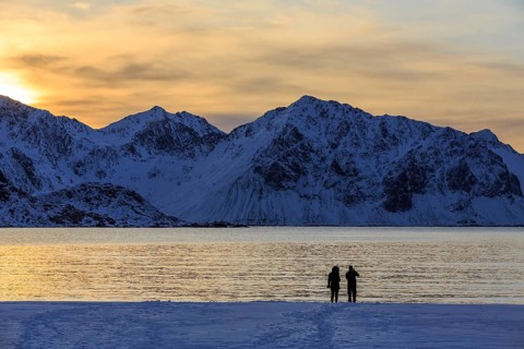 Stroller on snowy Haukland beach