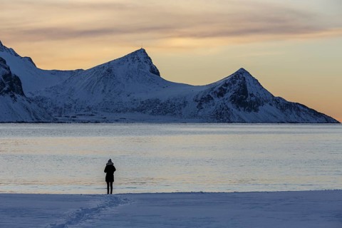 Stroller on snowy Haukland beach