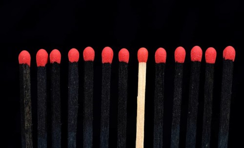 A bright match among several black matches
