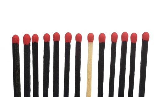 A bright match among several black matches
