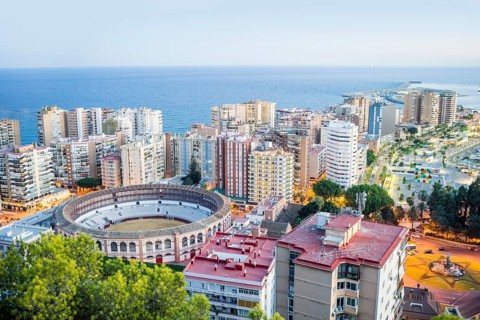 Malaga bullring surrounded by residential buildings next to the sea