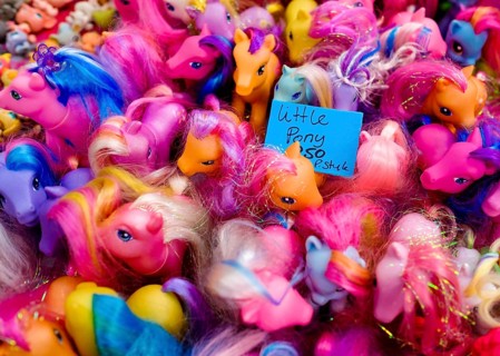 Plastic horses in a stall at a flea market