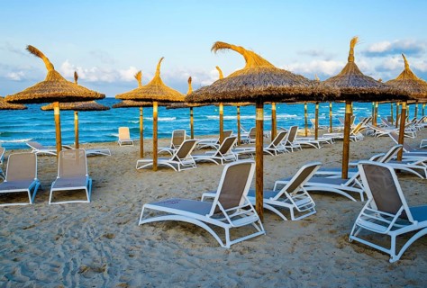 Empty sunbeds and parasols on the beach