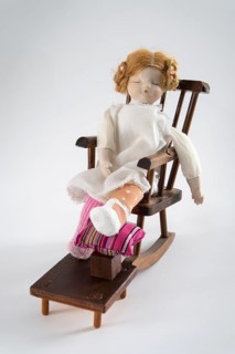 Doll asleep in rocking chair