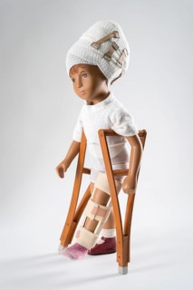 Doll with bandage on head