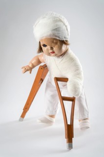 Doll with bandage on head