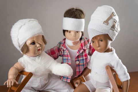 Three dolls sitting