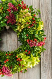 Autumn wreath on wooden wall