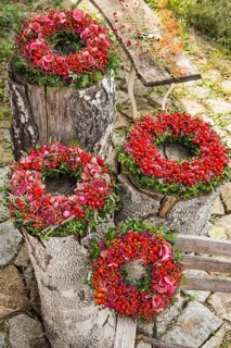 Four autumn wreaths on birch trunks
