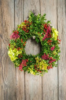 Autumn wreath on wooden wall
