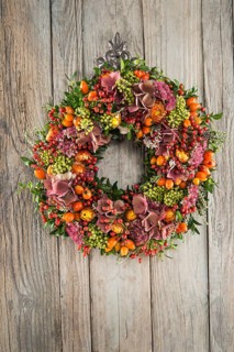 Autumn wreath on wooden wall