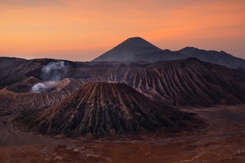 Volcanic pipes with smoking volcano Gunung Bromo