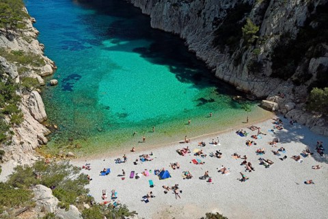 Tourists at beach with turquoise water