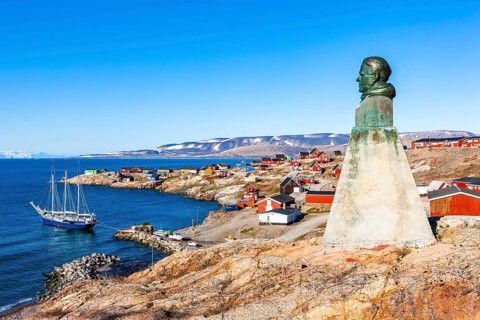 East Greenland town Ittoqqortoormiit with view to the harbour and the statue of Einar Mikkelsen