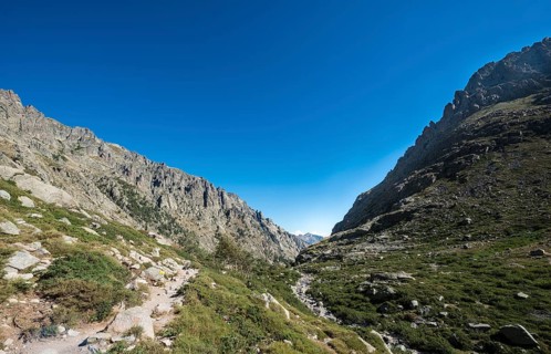 Restonica river flows at its source through mountain valley