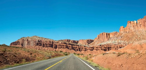 Red rugged sandstone cliffs on Highway 24