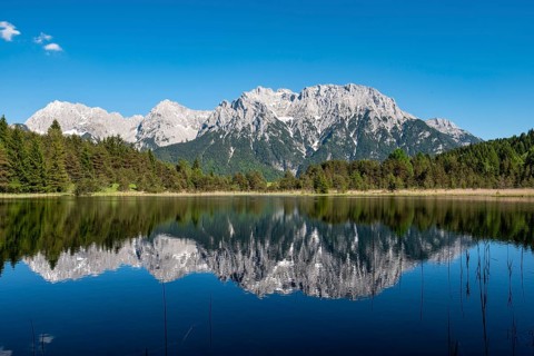 Western Karwendelspitze is reflected in Lake Luttensee