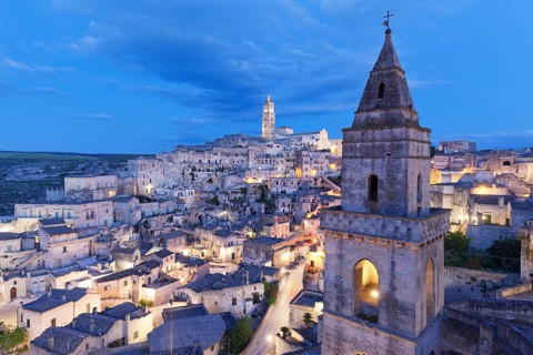 View of Church of San Pietro Barisano and Sasso Barisano historic centre with cathedral at dusk