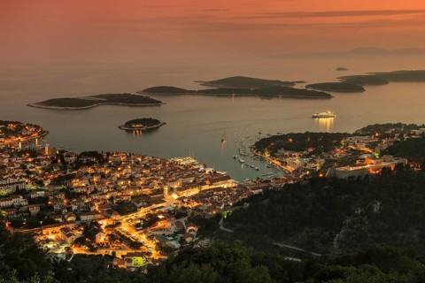 Town view Hvar with harbour and Pakleni islands at sunset