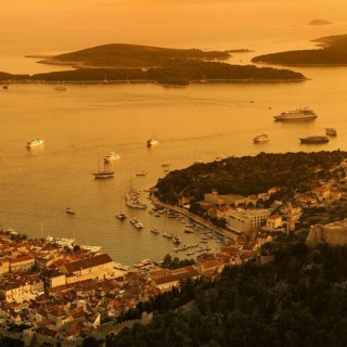 Town view Hvar with harbour and Pakleni islands at sunset