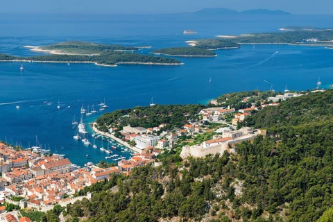 Overview of old town with harbour and fortress and Pakleni islands