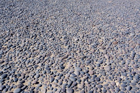 Round black pebbles on the beach