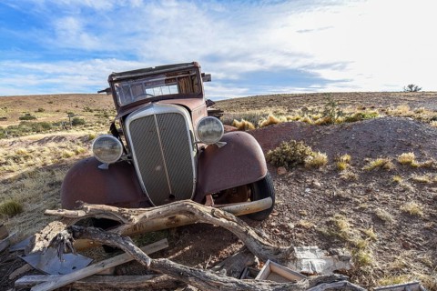 Pampa with old car on a farm in Bosques Petrificados de Jaramillo National Park