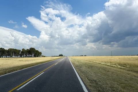Long straight road through the Pampa to the horizon