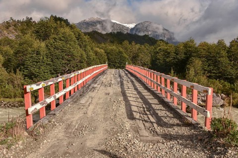Simple wooden bridge at Mirador Glaciar Exploradores over Rio Exploradores at Puerto Rio Tranquilo
