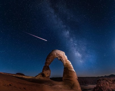 Natural Arch Delicate Arch with Milky Way and shooting star at night