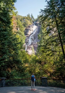 Young woman standing in front of Shannon Falls