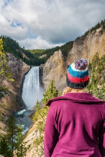 Young woman looking at a waterfall