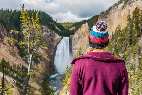 Young woman looking at a waterfall