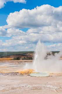 Steaming geyser with water fountain