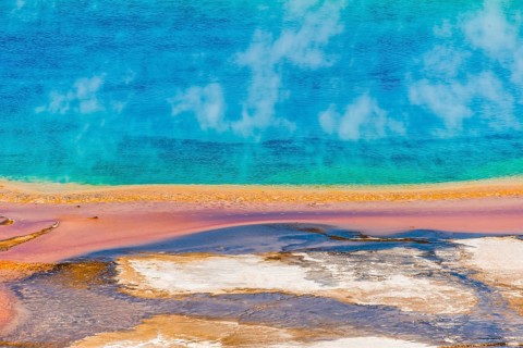Colored mineral deposits at the edge sr steaming hot spring