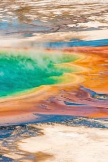 Colored mineral deposits at the edge sr steaming hot spring