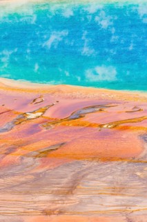 Colored mineral deposits at the edge sr steaming hot spring