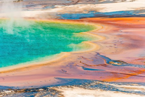 Colored mineral deposits at the edge sr steaming hot spring