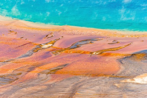 Colored mineral deposits at the edge sr steaming hot spring