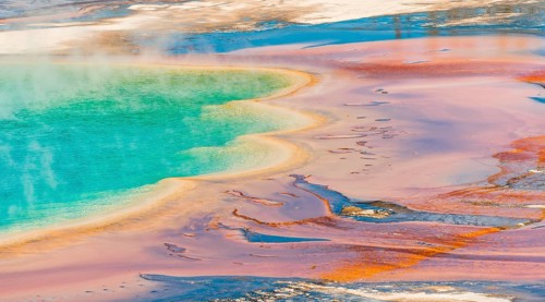 Colored mineral deposits at the edge sr steaming hot spring